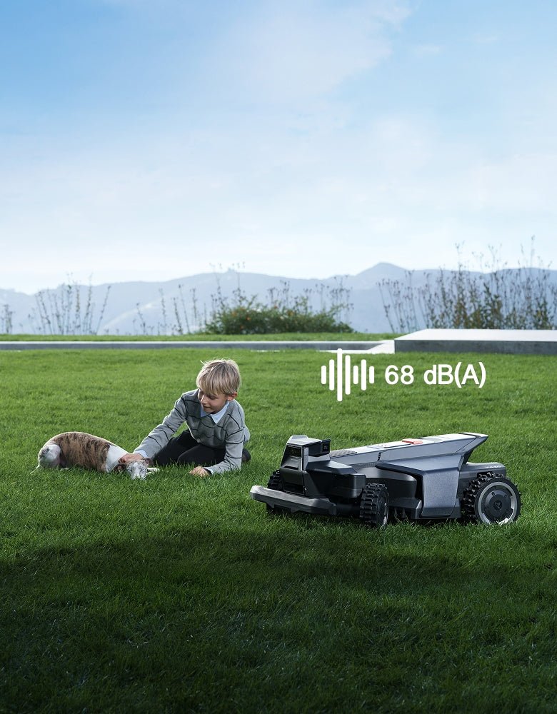 Navimow i110N robot lawn mower with a boy and dog.