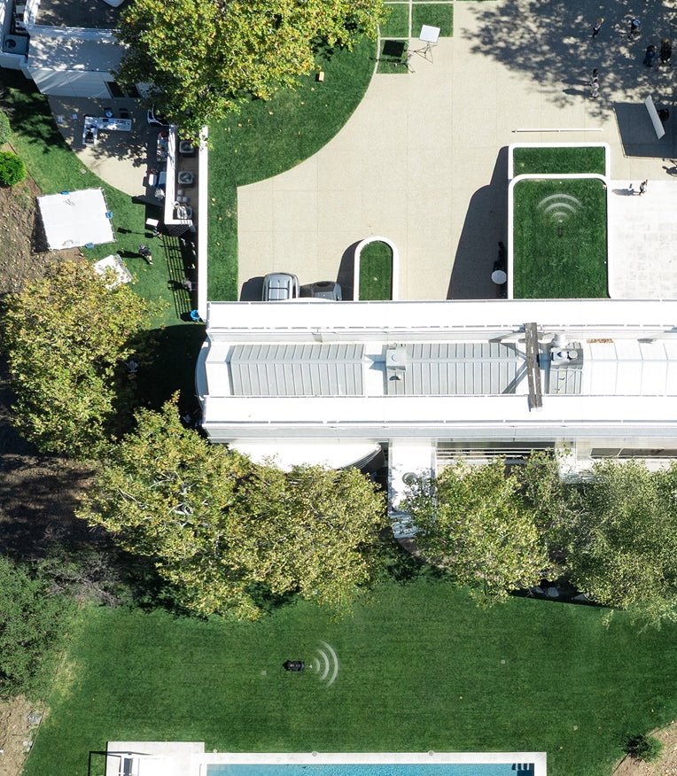 Navimow i110E robot lawn mower operates on a large lawn.